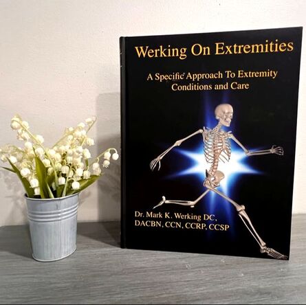 Front cover of Werking On Extremities Textbook displayed on an accent table